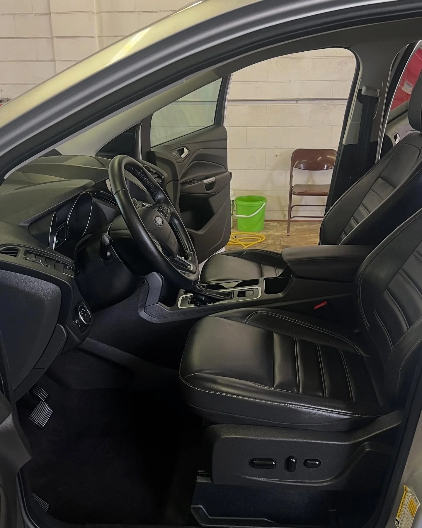 Clean front floor and seat after an interior detail at MC Auto Detailing