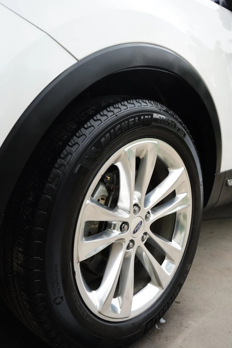 Clean Ford wheel and dressed tire after a detail at MC Auto Detailing